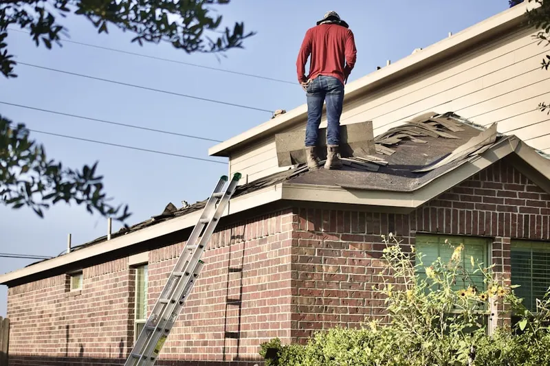 Professional roofer working on a residential roof in Sun Groves